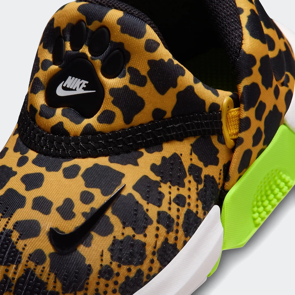 Close-up of a Nike Swoosh Go Baby/Toddler Shoe featuring a black and tan leopard print, a black Swoosh, and neon green sole