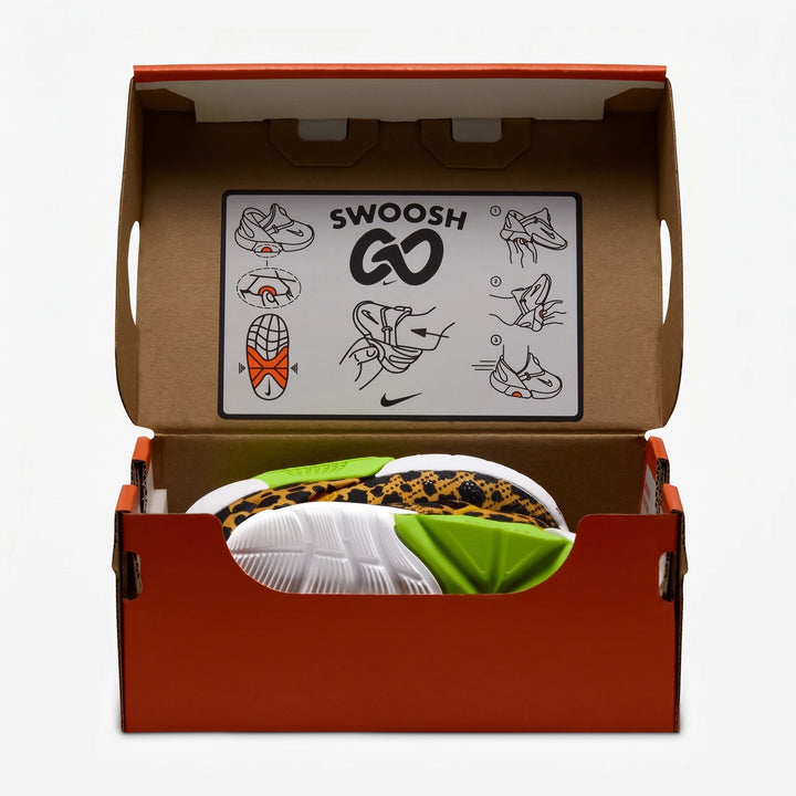 Nike Swoosh Go Baby/Toddler Shoes in open shoebox, showcasing leopard print upper, white sole, and lime green accents.