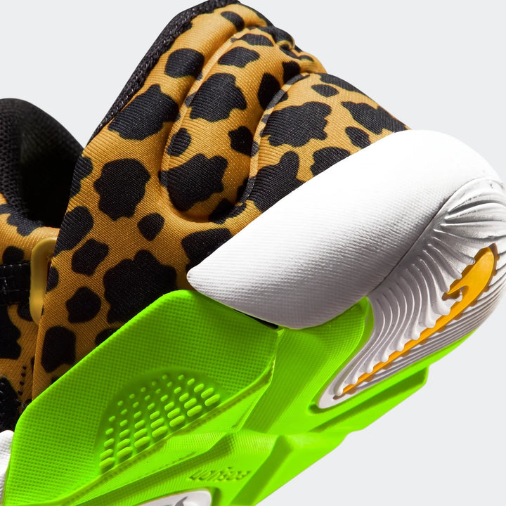 Close-up side view of a Nike Swoosh Go baby toddler shoe featuring a brown and black leopard print upper with a neon green