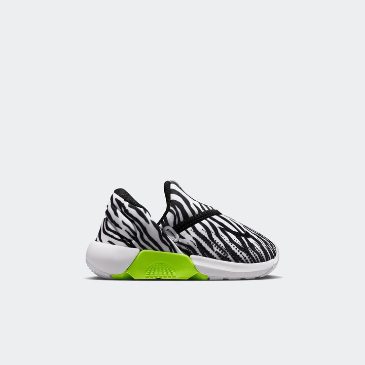 A Nike Swoosh Go Baby/Toddler shoe, featuring a black and white zebra-like pattern with a bright neon green sole accent,