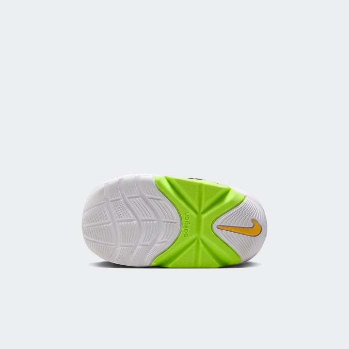 Bottom view of a Nike Swoosh Go Baby/Toddler shoe with a white sole, neon green midfoot, and gold Nike Swoosh logo,