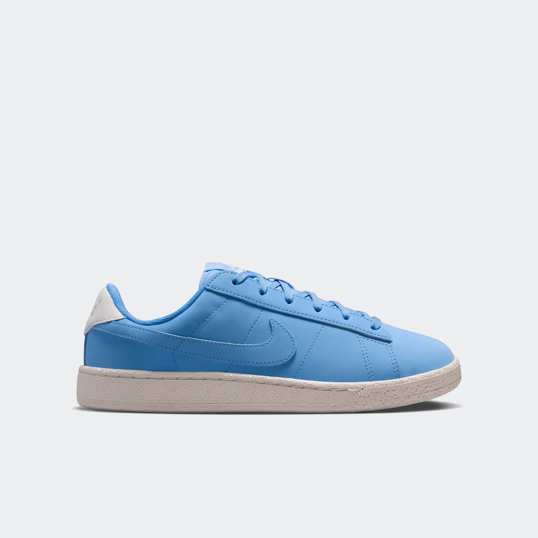 A blue Nike Tennis Classic Big Kids' shoe, featuring a white heel accent and light sole, shown from the side view.