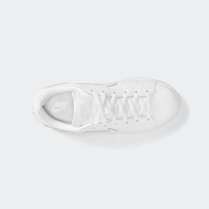 Top-down view of a white Nike Tennis Classic Big Kids' shoe, featuring clean white leather and visible white laces.