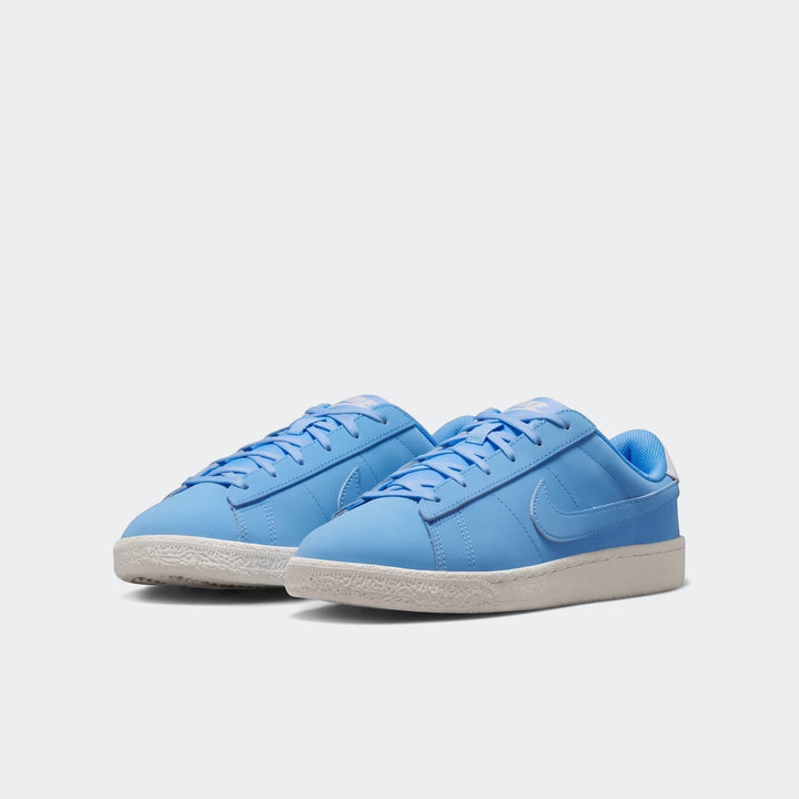 Light blue Nike Tennis Classic Big Kids' Shoes with white soles, featuring a low-top design, shown from a front-right view.