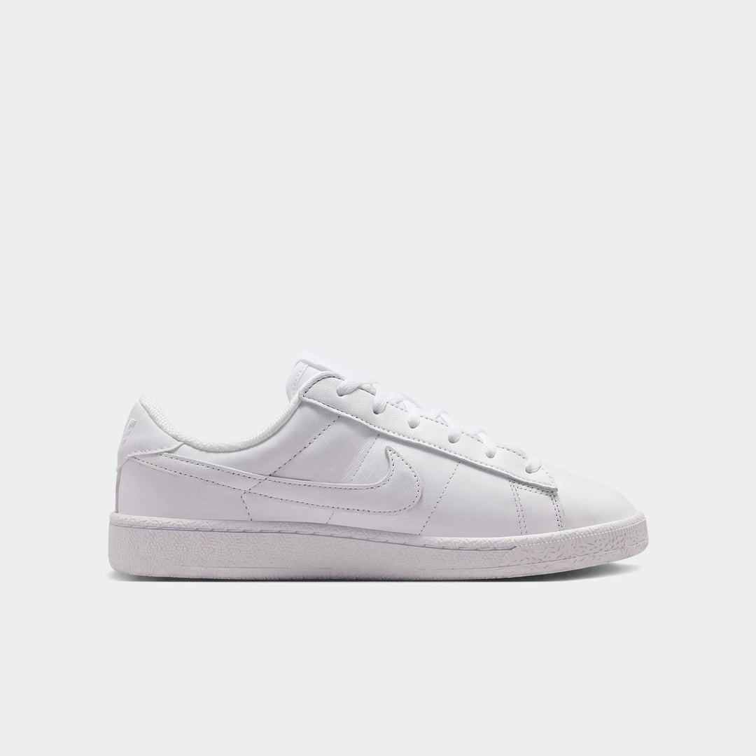 White leather Nike Tennis Classic Big Kids' low-top sneaker, visible from the side.