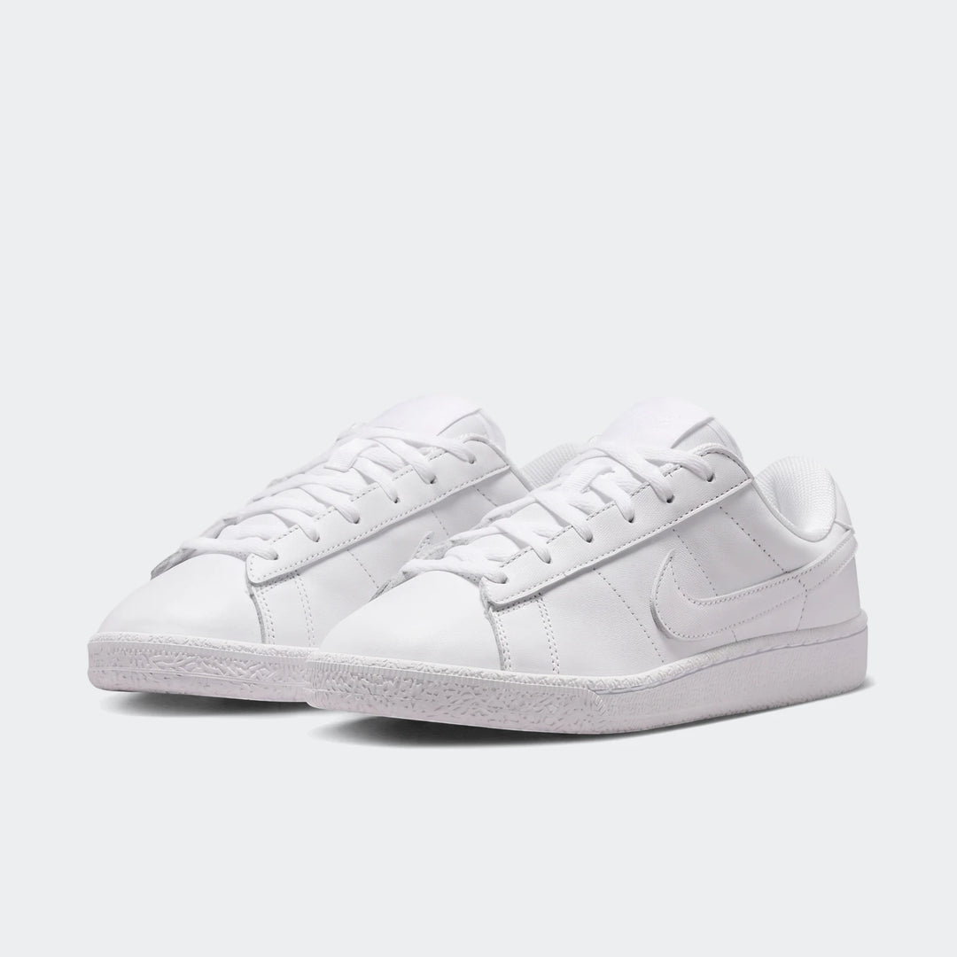 Pair of white Nike Tennis Classic Big Kids' sneakers with laces, made from a smooth leather-like material.