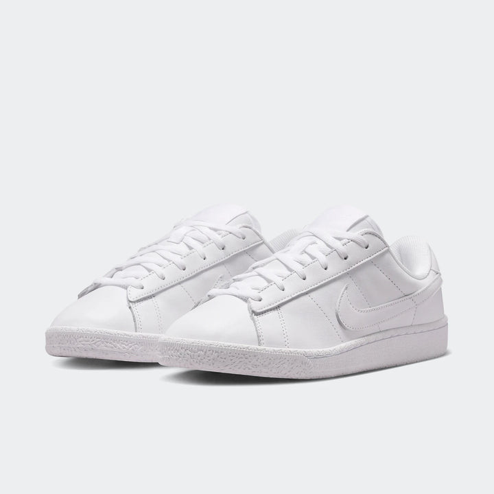 Pair of white Nike Tennis Classic Big Kids' sneakers with laces, made from a smooth leather-like material.