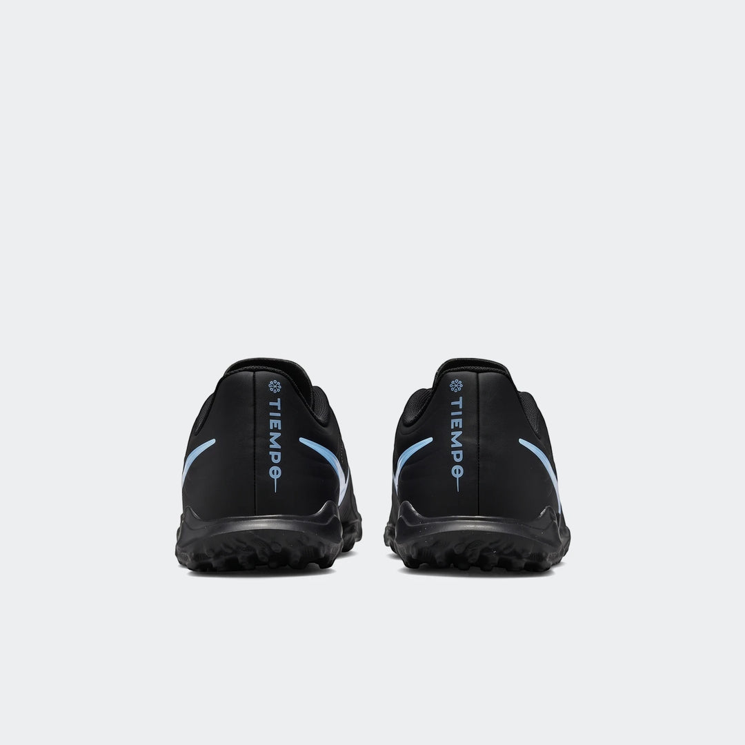 Pair of black Nike Tiempo Maestro Club TF soccer boots, shown from the rear, featuring light blue branding and textured