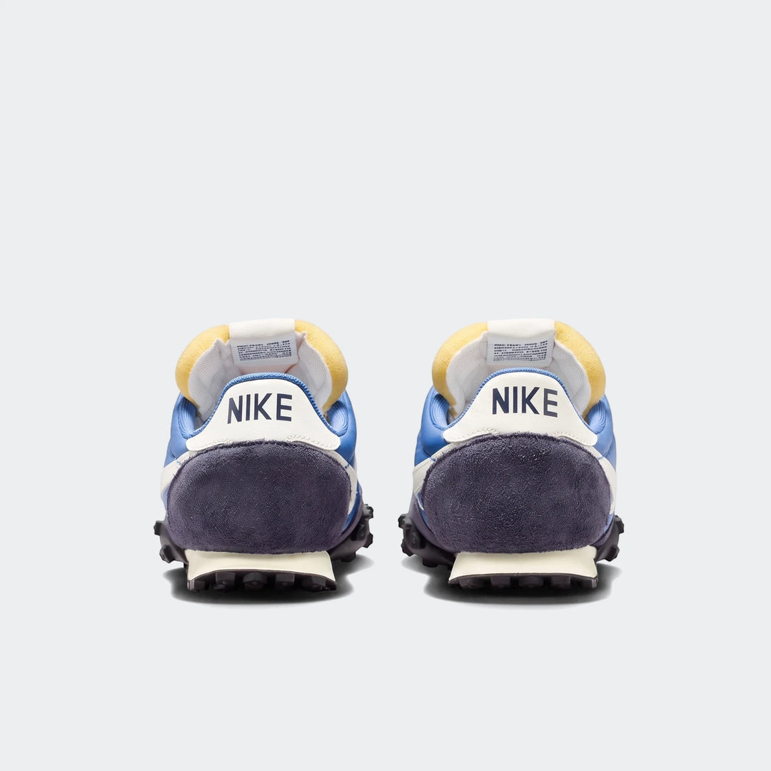 Rear view of two Nike Waffle Racer Men's Shoes in blue and dark blue, showcasing the iconic 'NIKE' logo and studded outsole.