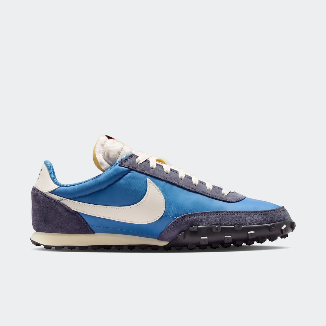 Blue and dark gray Nike Waffle Racer men's shoes with white laces and swoosh, featuring a durable waffle outsole, captured