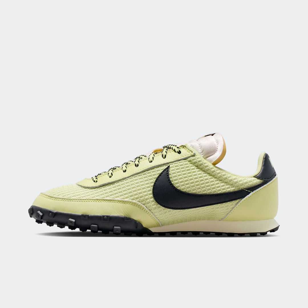 Nike Waffle Racer SE men's running shoe in pale green with black swoosh and lugged rubber outsole, shown in a side profile