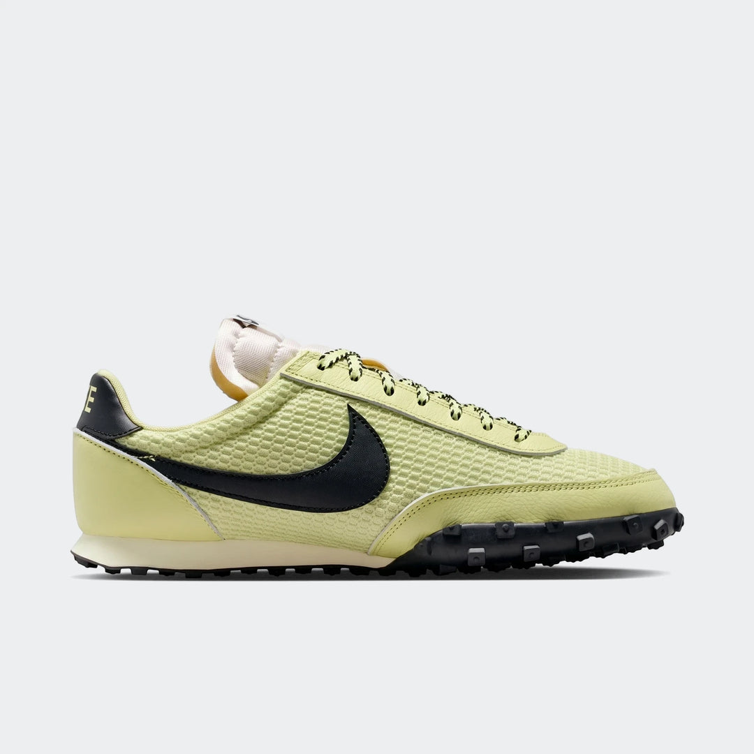 Light green Nike Waffle Racer Se men's shoes in a side profile, showcasing the black Swoosh and lugged outsole.