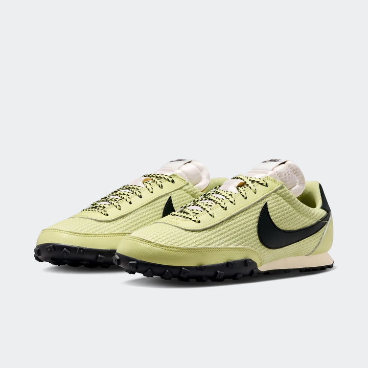 A pair of Nike Waffle Racer Se men's shoes in lime green with a black swoosh and waffle sole, viewed from a side angle.