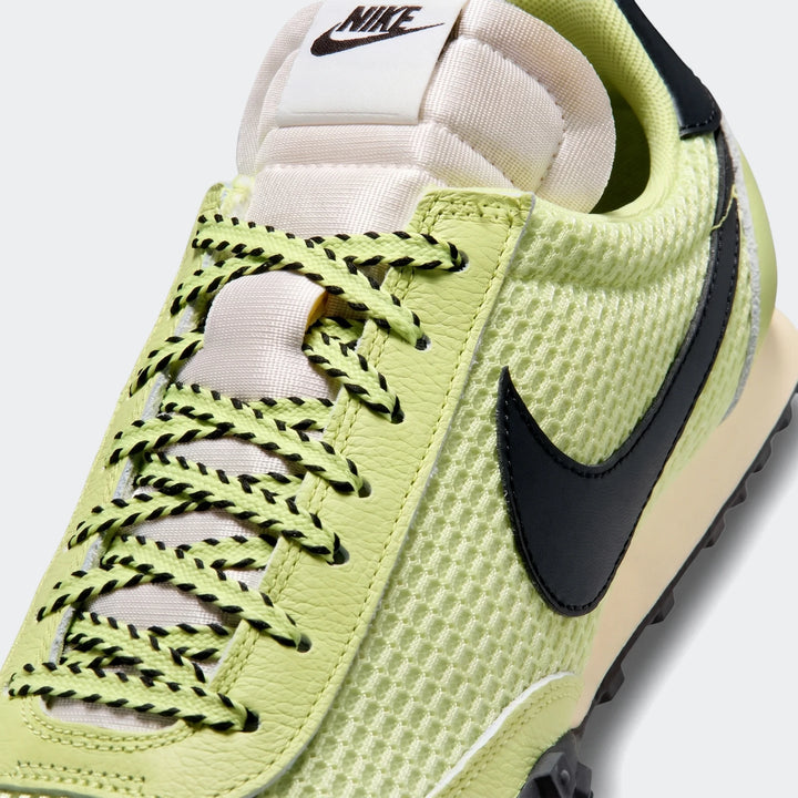 Close-up view of the Nike Waffle Racer SE men's shoes in green, featuring lime green mesh and leather, black laces, and