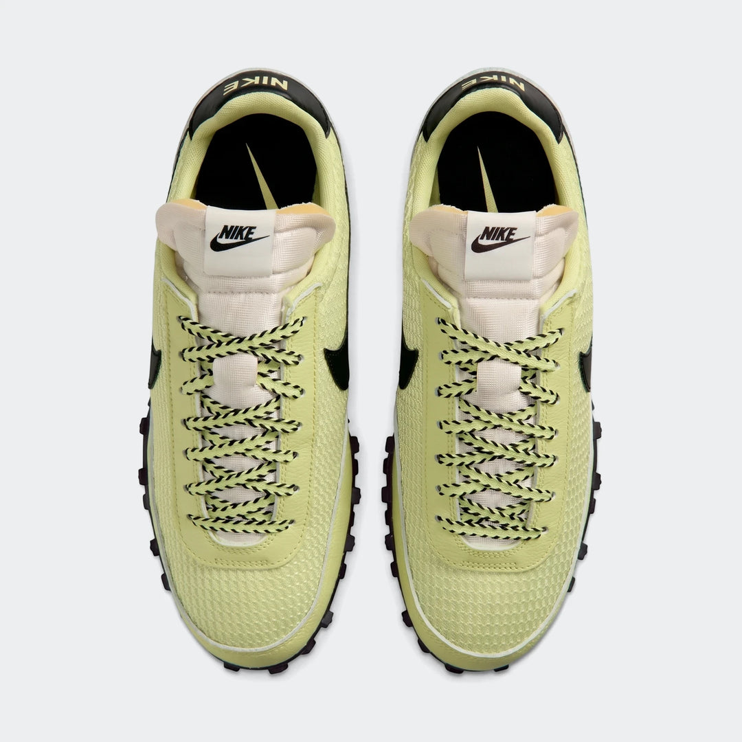 Top-down view of a pair of light green Nike Waffle Racer SE men's shoes with black and green speckled laces.