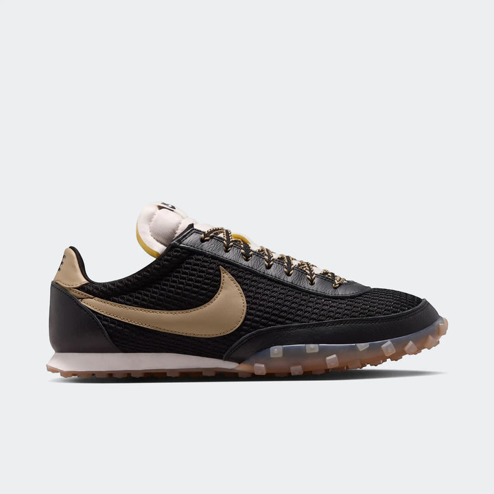 Nike Waffle Racer Se men's shoes in black mesh with tan gold swoosh and translucent studded outsole, side view.