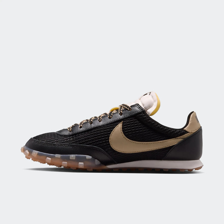 Nike Waffle Racer Se men's shoe in black with tan swoosh, side view, featuring a white midsole and translucent gum waffle