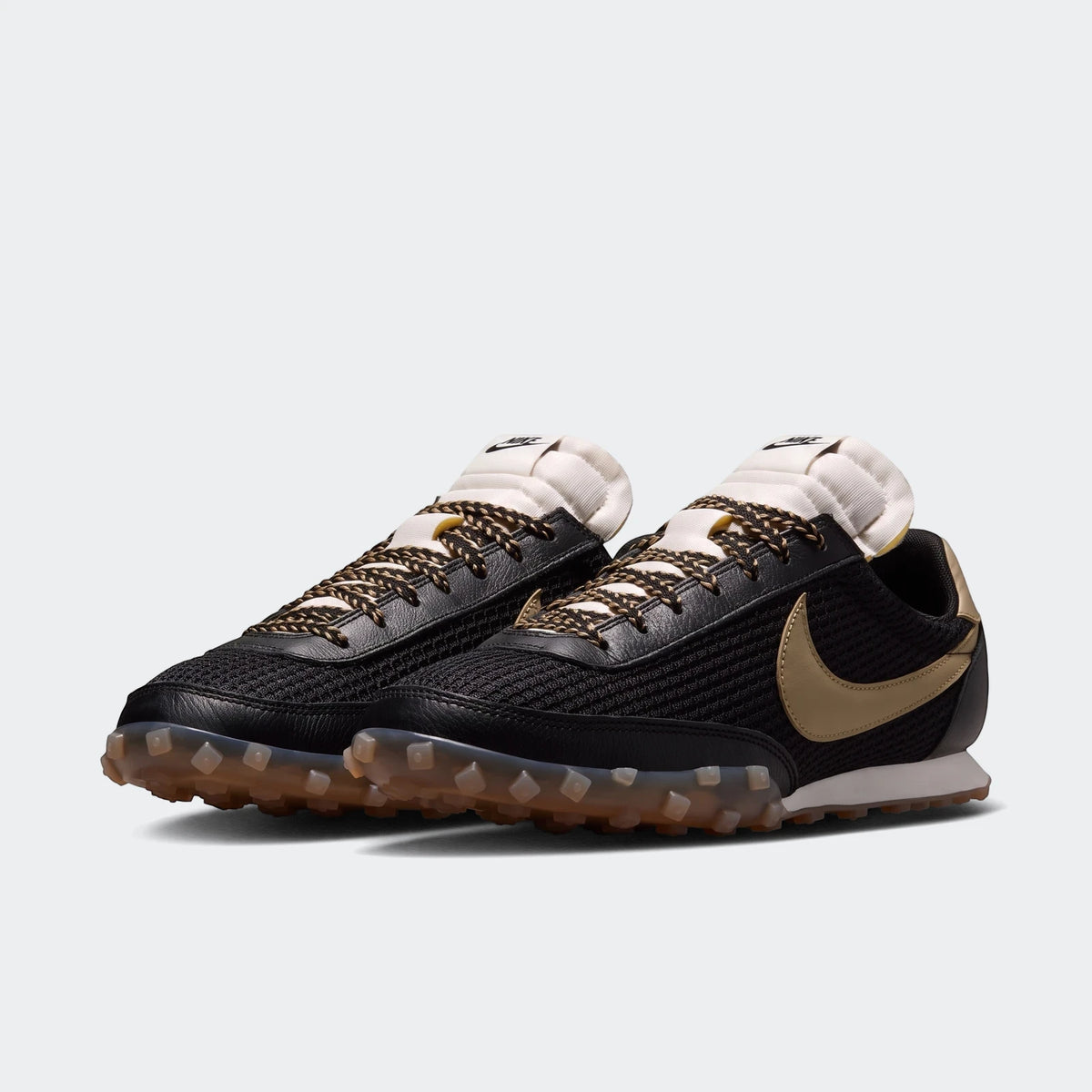 Pair of Nike Waffle Racer Se Men's Shoes in black mesh and leather with gold swoosh and translucent studded outsole, side