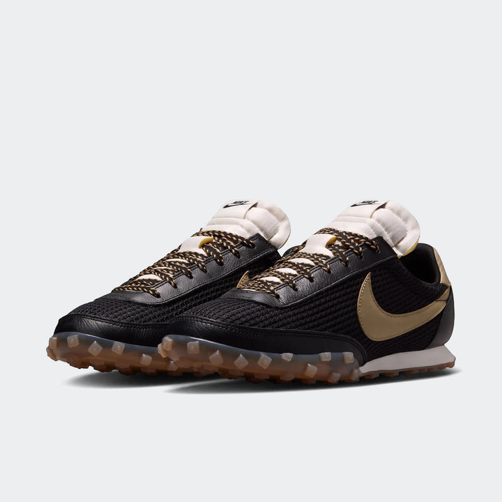 Pair of Nike Waffle Racer Se Men's Shoes in black mesh and leather with gold swoosh and translucent studded outsole, side