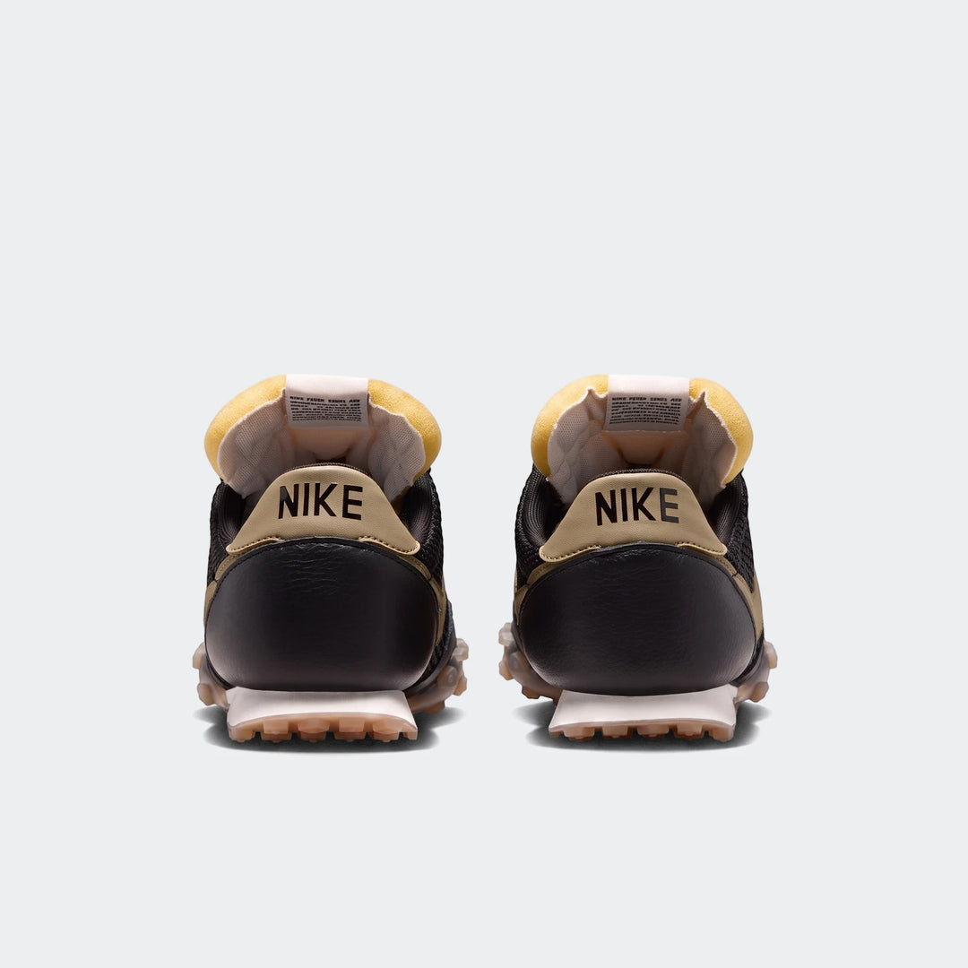 Rear view of Nike Waffle Racer SE men's shoes in black and tan, featuring a distinctive waffle outsole and yellow padded