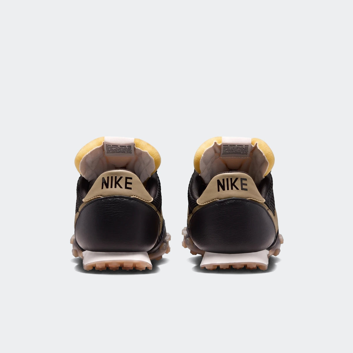Rear view of Nike Waffle Racer SE men's shoes in black and tan, featuring a distinctive waffle outsole and yellow padded