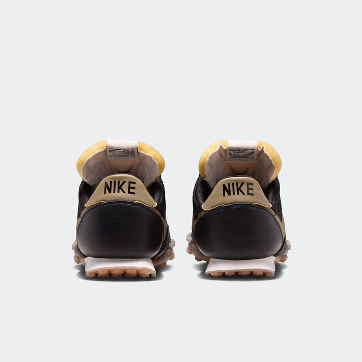 Rear view of Nike Waffle Racer SE men's shoes in black and tan, featuring a distinctive waffle outsole and yellow padded