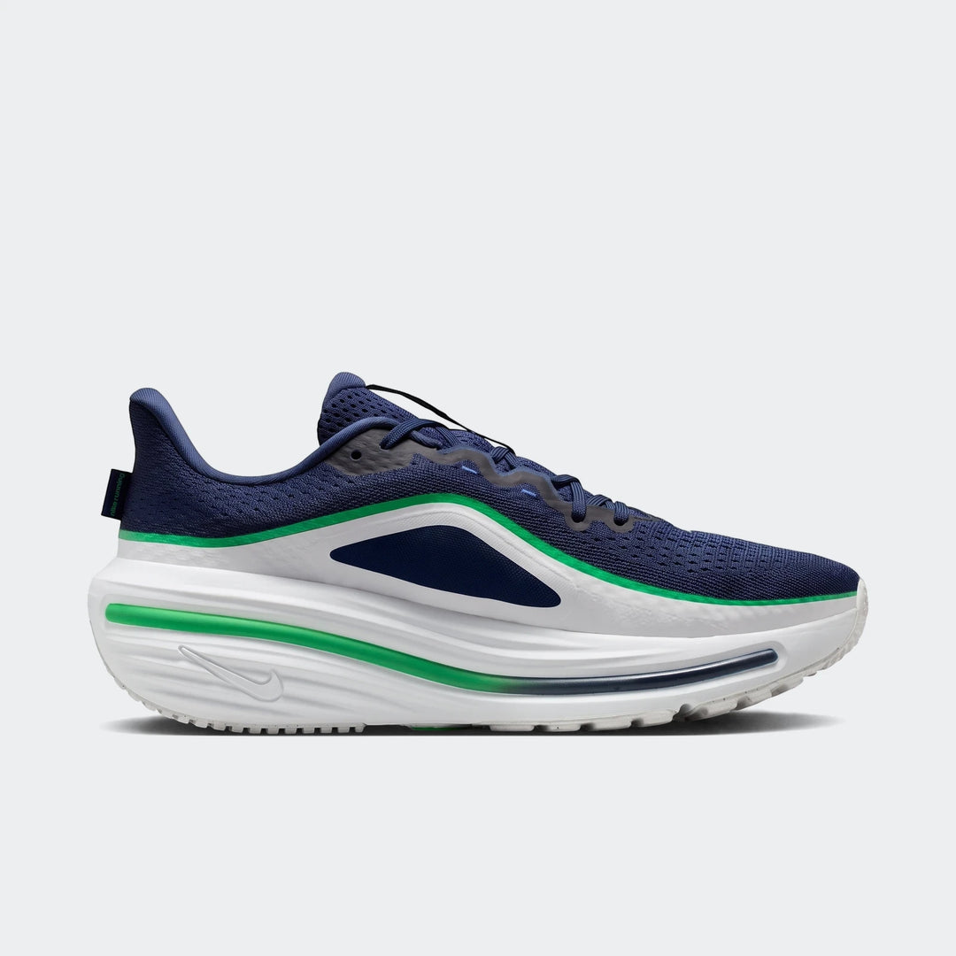Navy blue, white, and green Nike Winflo 12 men's road running shoe, shown from a side profile.