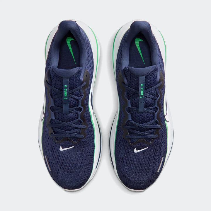 A pair of navy blue Nike Winflo 12 men's road running shoes with green accents and white soles, viewed from directly above.