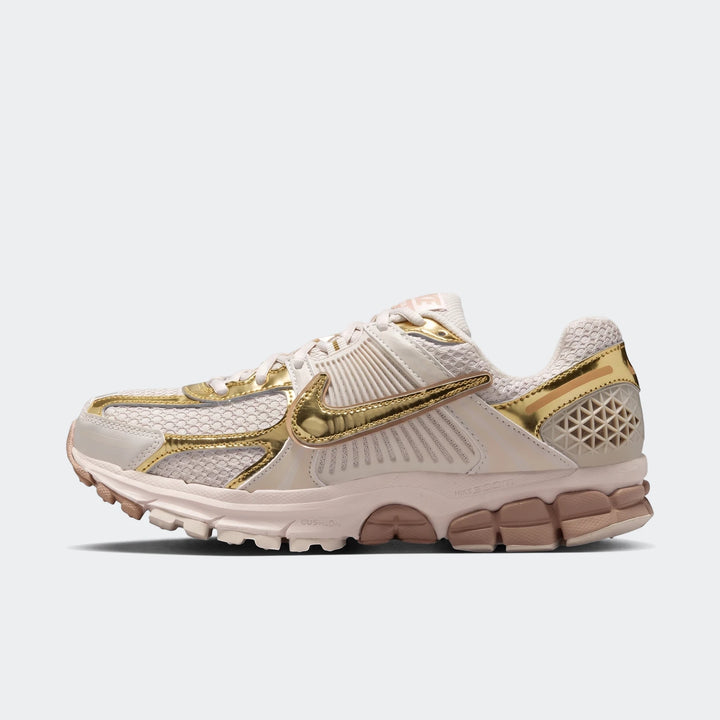 Nike Zoom Vomero 5 Women's Shoes in off-white and metallic gold, featuring a mesh upper and detailed sole, viewed from the