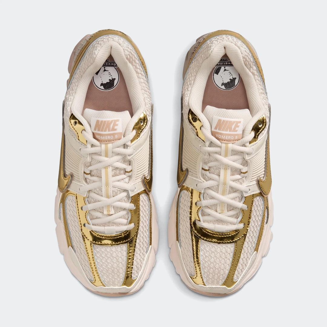Pair of Nike Zoom Vomero 5 Women's Shoes in cream with metallic gold accents, shown from a top-down perspective.