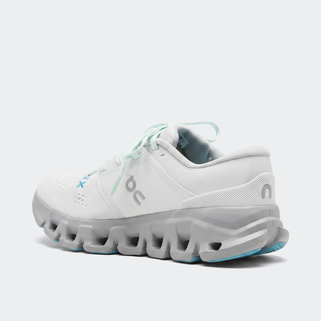 White and gray On Running Cloud X 5 sneakers with blue accents, shown from a rear-side view on a flat surface.
