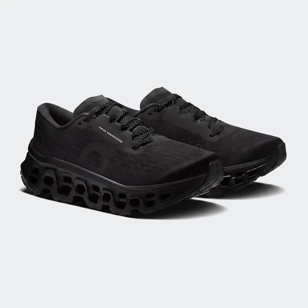 Pair of On Running Cloudmonster 3 Black Running Sneakers, featuring a mesh upper and chunky CloudTec sole.