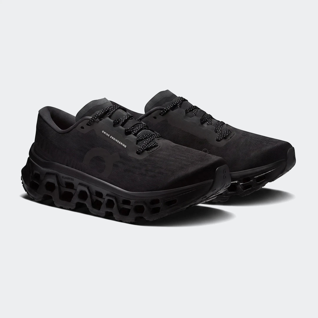 Pair of On Running Cloudmonster 3 Black Running Sneakers, featuring a mesh upper and chunky CloudTec sole.