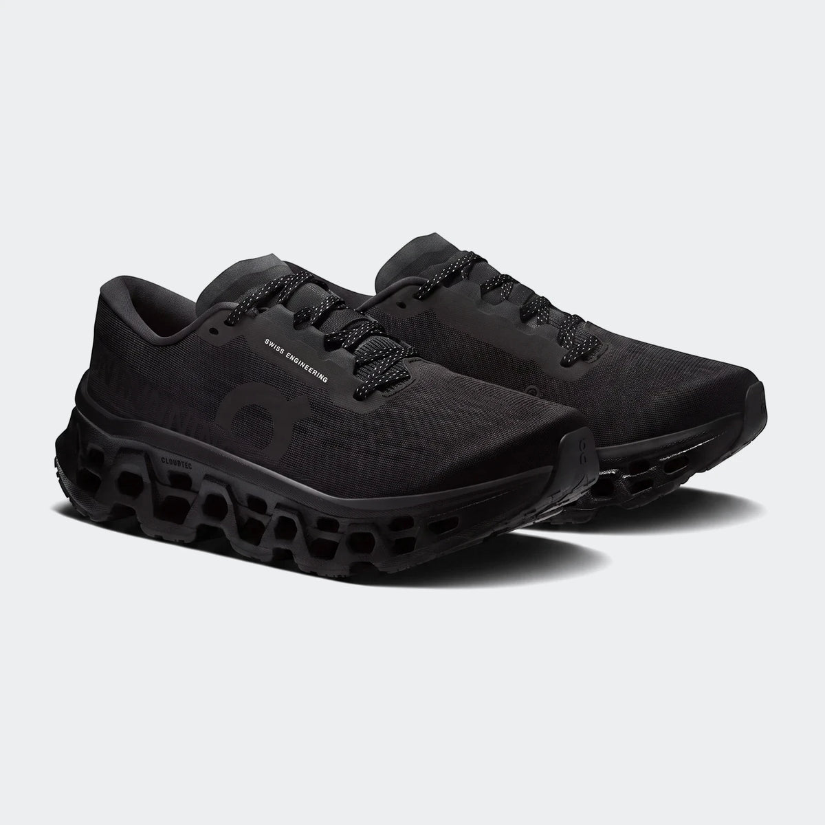 Pair of On Running Cloudmonster 3 Black Running Sneakers, featuring a mesh upper and chunky CloudTec sole.