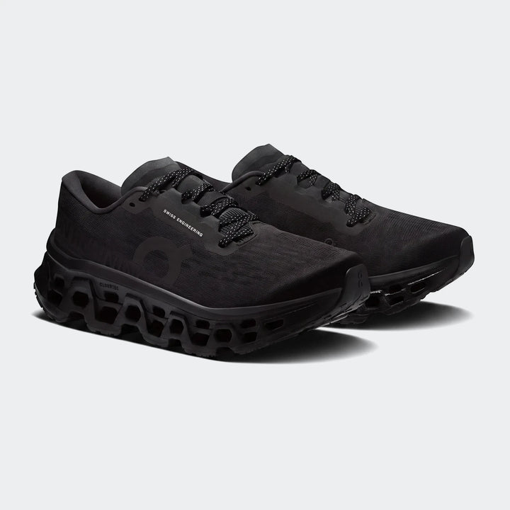 Pair of On Running Cloudmonster 3 Black Running Sneakers, featuring a mesh upper and chunky CloudTec sole.