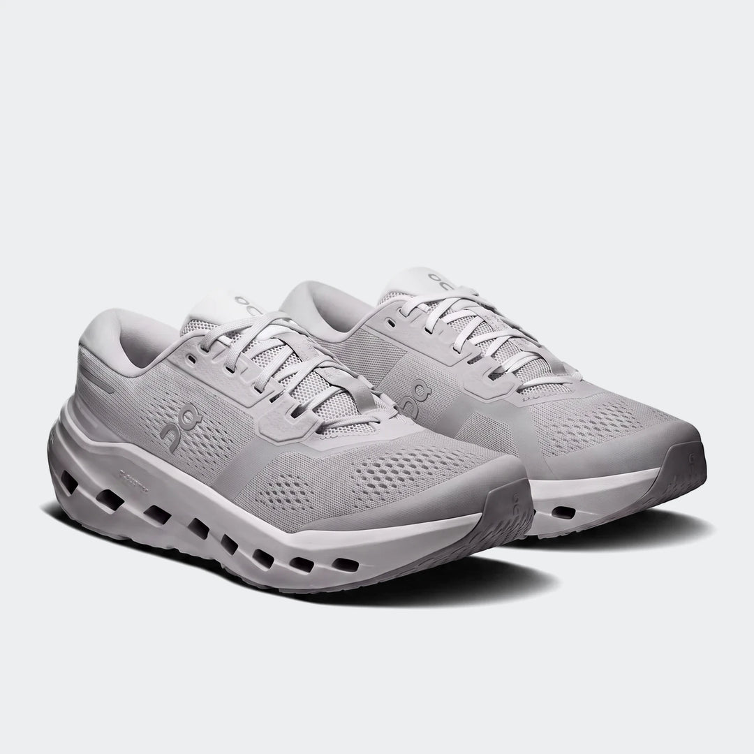 A pair of light grey On Running Cloudrunner 3 Glacier sneakers, showcasing their design and sole technology from an angled