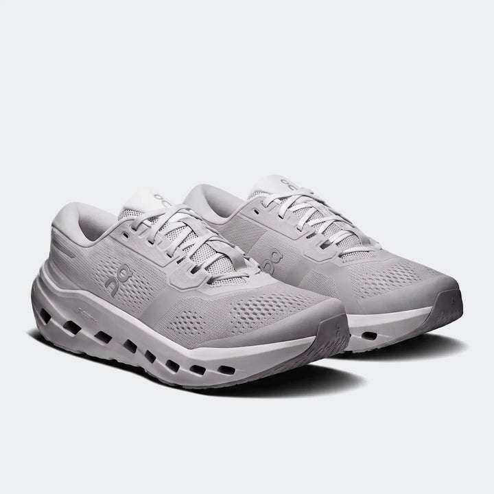 A pair of light grey On Running Cloudrunner 3 Glacier sneakers, showcasing their design and sole technology from an angled