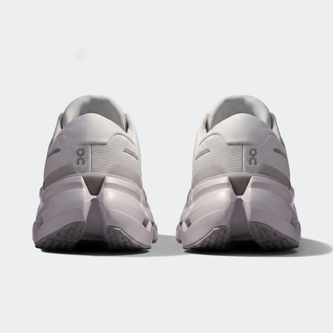 Rear view of two On Running Cloudrunner 3 Glacier sneakers, showcasing their light grey mesh upper and supportive sole.