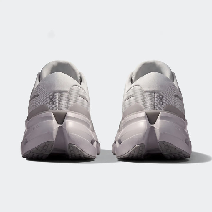 Rear view of two On Running Cloudrunner 3 Glacier sneakers, showcasing their light grey mesh upper and supportive sole.