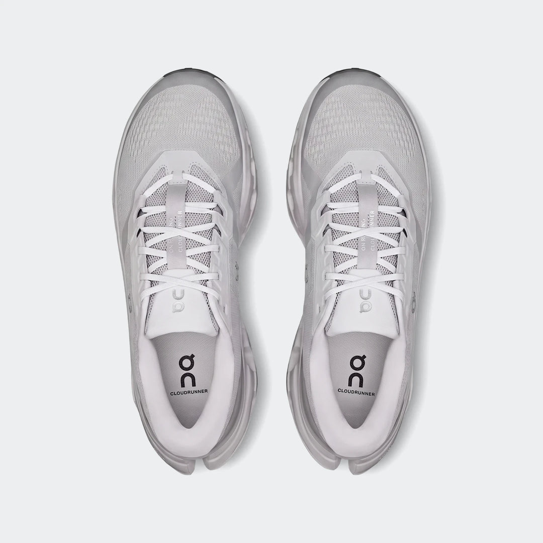 Top-down view of two On Running Cloudrunner 3 Glacier white and light gray running sneakers with prominent branding.