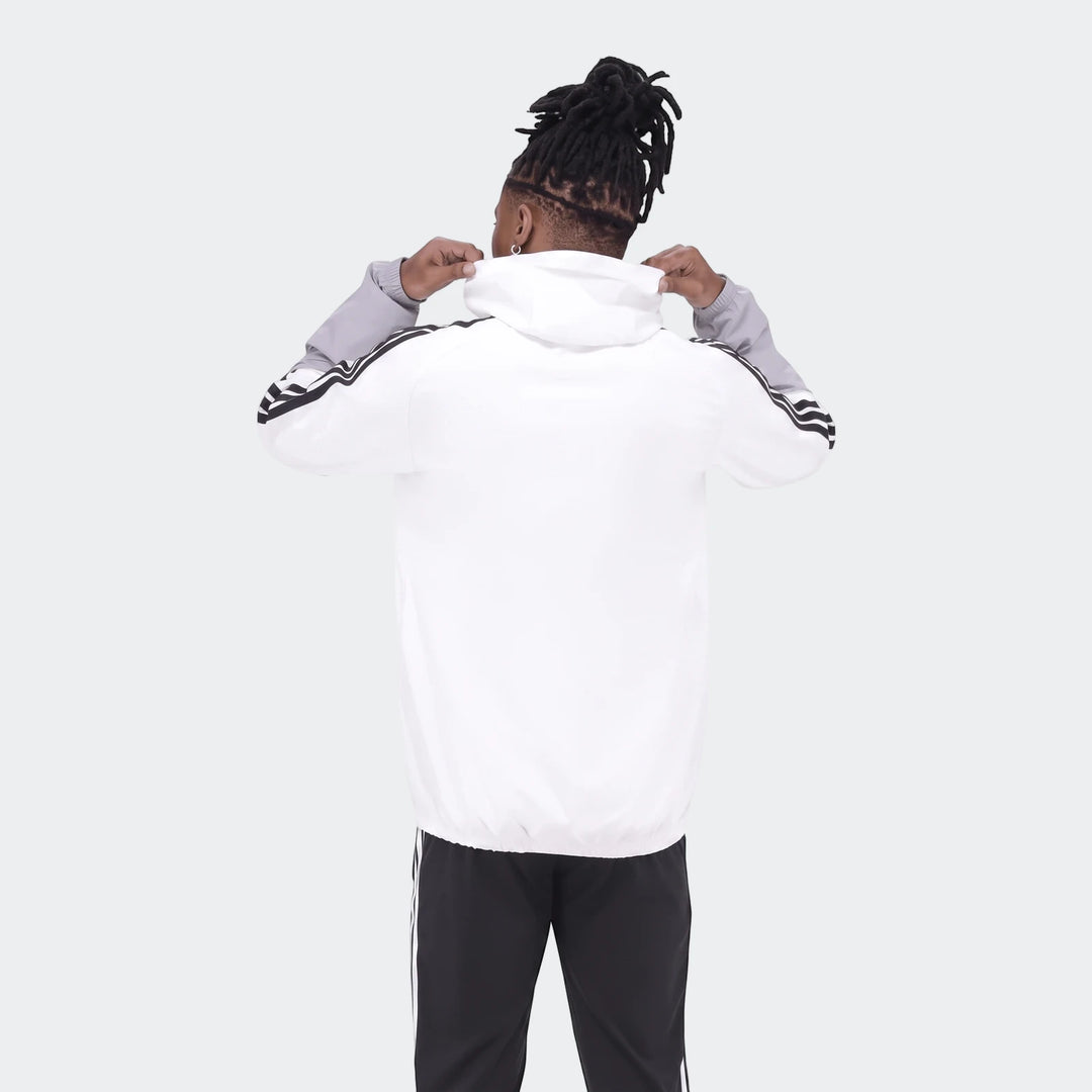 Op Tiro26C Aw Jkt in white and grey with black stripes, seen from the back on a person with dreadlocks.