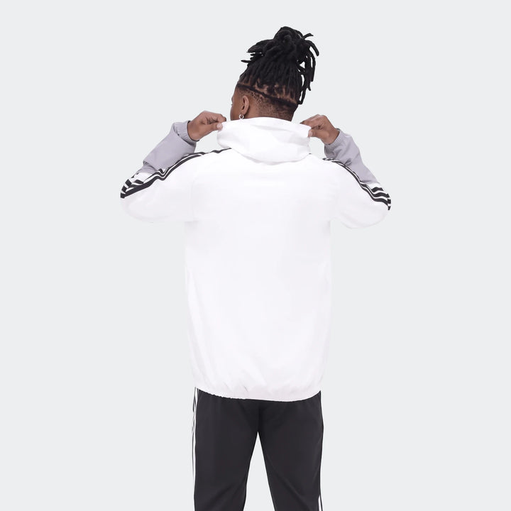 Op Tiro26C Aw Jkt in white and grey with black stripes, seen from the back on a person with dreadlocks.