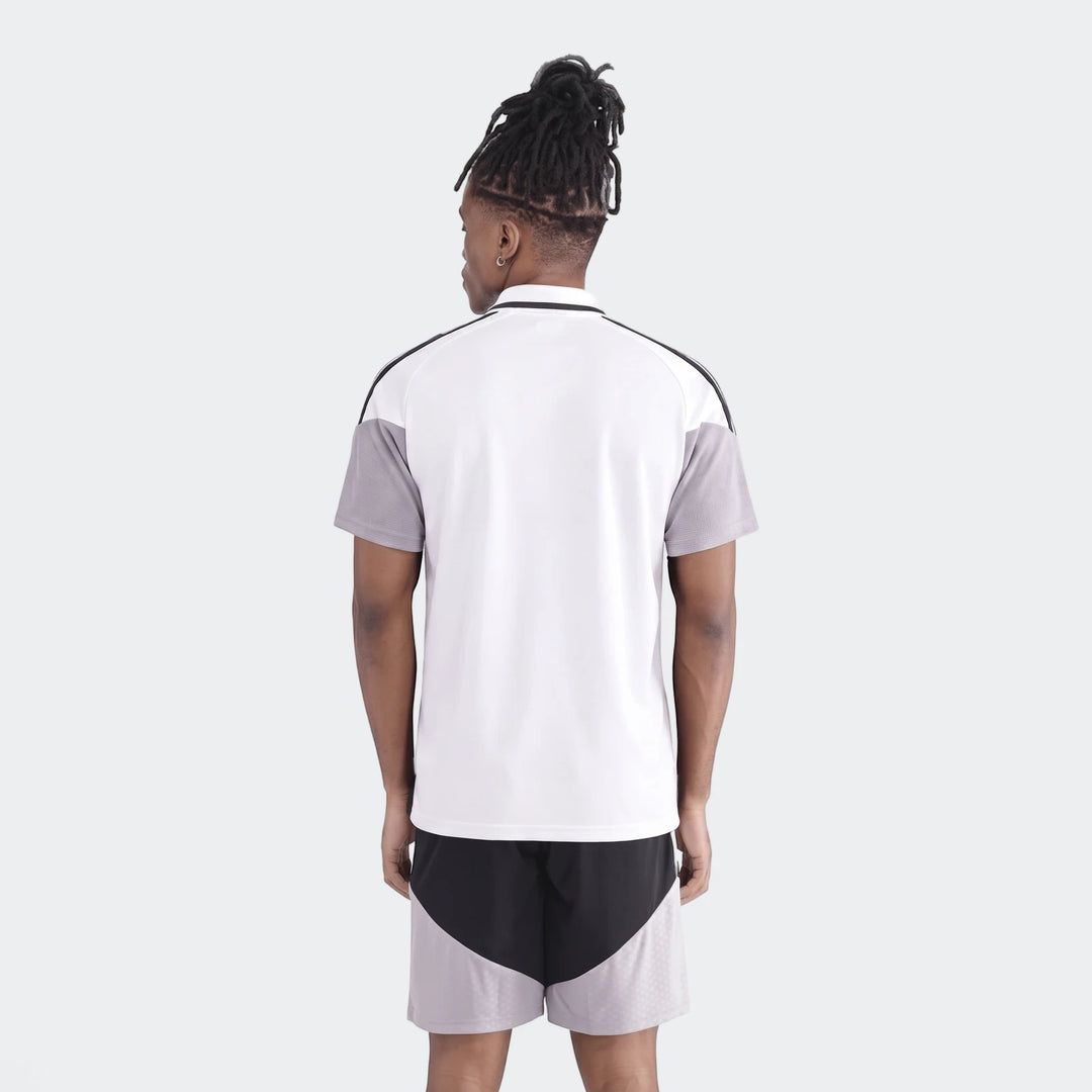 Male model from back wearing white and grey Op Tiro26C Polo shirt and black athletic shorts with grey pattern.