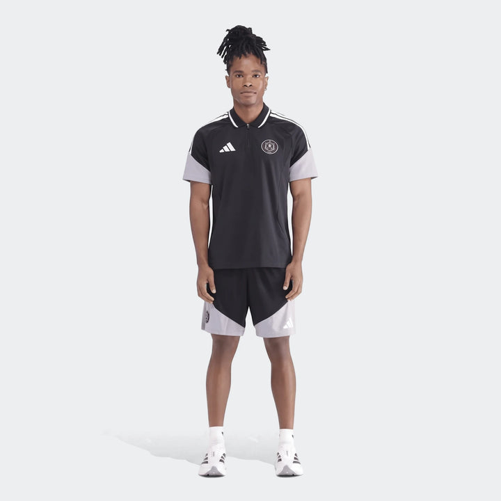 Men's black and grey Adidas Tiro26C polo shirt and matching shorts, worn by a male model standing in a full body view.