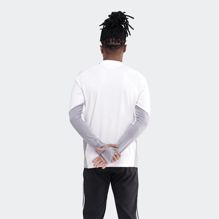 Op Tiro26C Top in white and grey, worn by a person from the back with hands clasped, paired with black track pants.