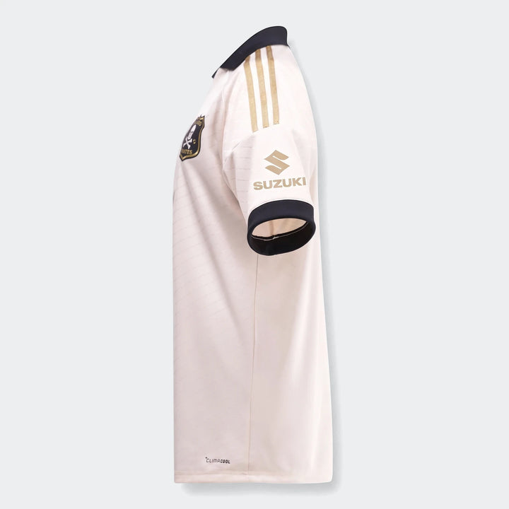 Orlando Pirates 26/27 Away Jersey, cream/off-white with black collar and gold stripes, Suzuki sponsor logo on sleeve.