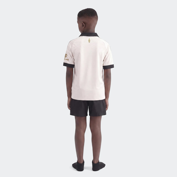 Orlando Pirates 26/27 Away Jersey for kids, modeled from the back, featuring a white shirt with black accents and gold