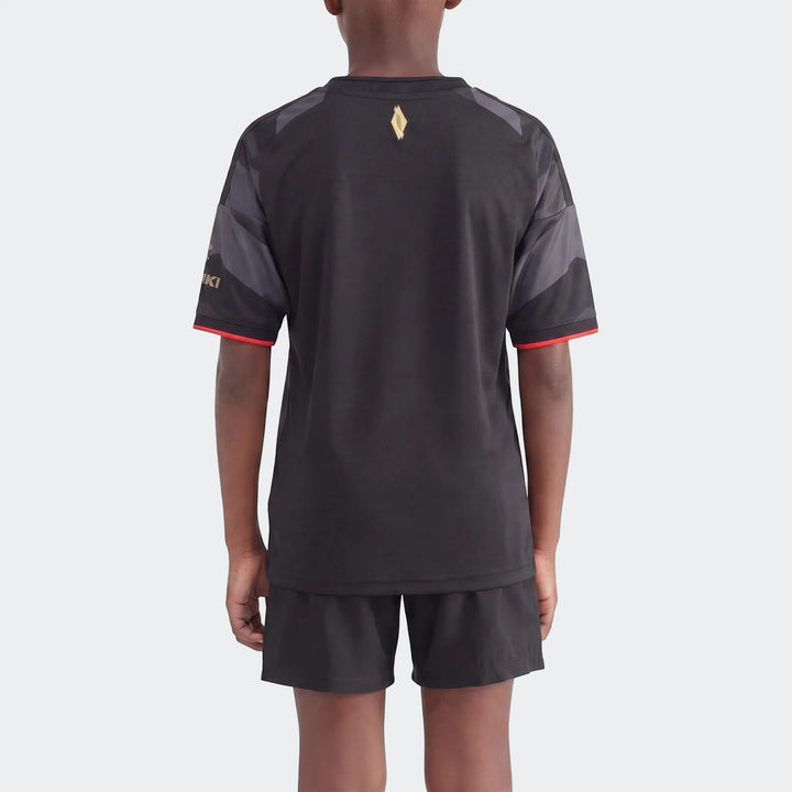 Orlando Pirates 26/27 Home Jersey for kids, black and grey with short sleeves, worn by a child model from the back.