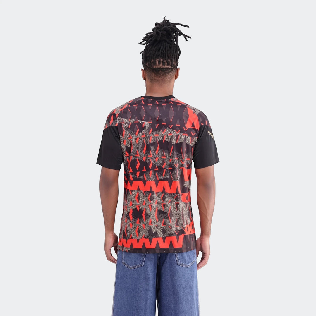 Back view of a male model wearing the Orlando Pirates 26/27 Pre Match Jersey, featuring a distinctive black and red