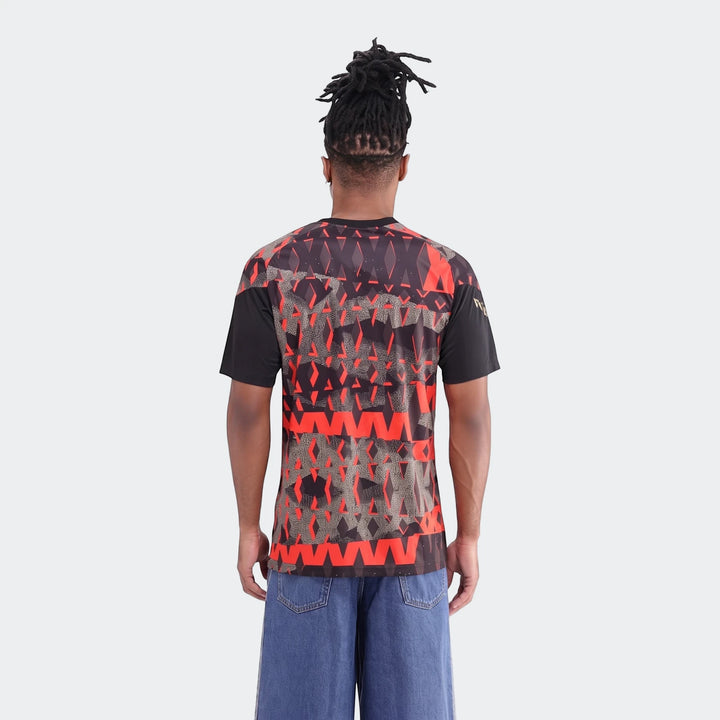 Back view of a male model wearing the Orlando Pirates 26/27 Pre Match Jersey, featuring a distinctive black and red